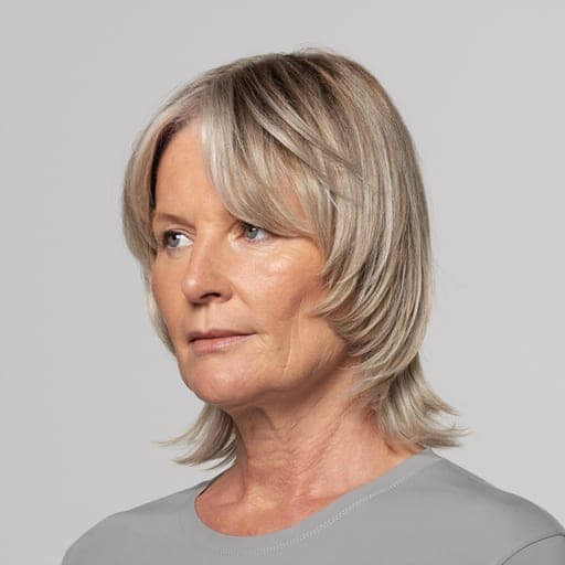 A woman with bixie: Between a bob and a pixie - short, layered, with length left over the ears and at the nape.