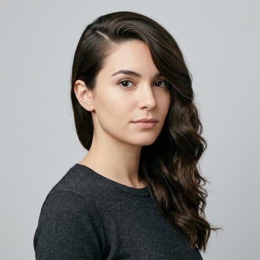 A woman with deep side part: Any length, parted far to one side so the hair falls asymmetrically across the forehead.