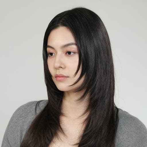 A woman with face-framing layers: Long layers cut shorter around the face only, starting at or below the cheekbone.