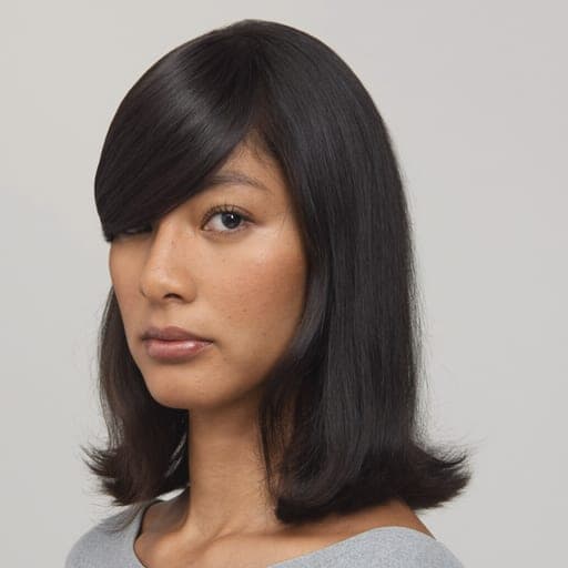 A woman with side-swept fringe: A fringe cut on an angle and worn across the forehead to one side.